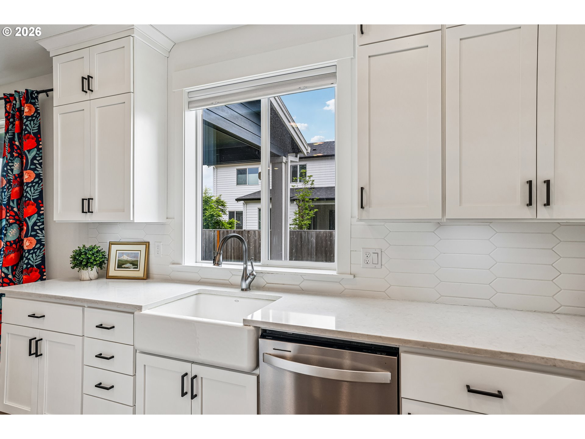 236 Northeast 17th Avenue Canby, OR 97013 - Photo 10 of 36 a sink with white cabinets and a window