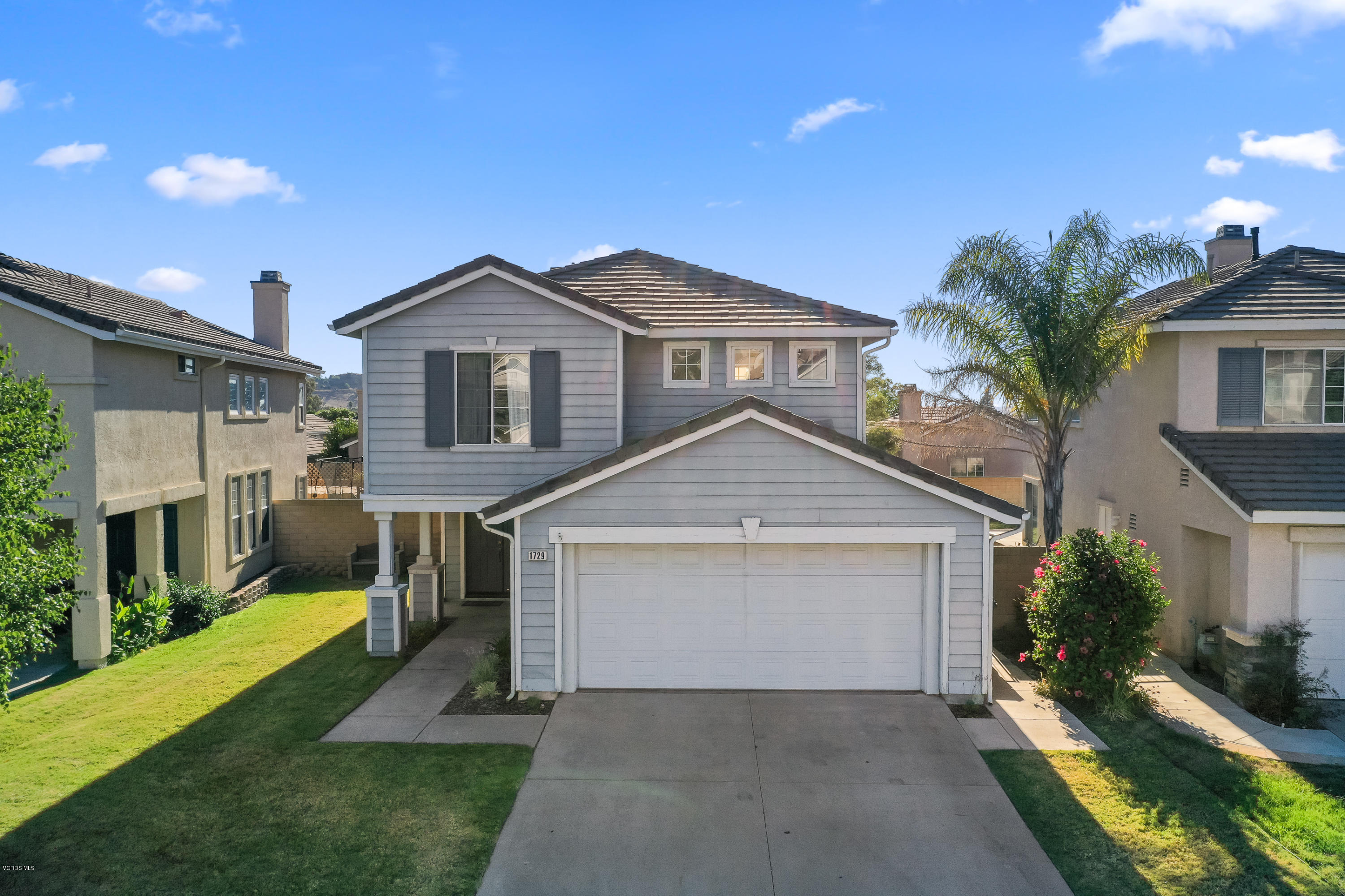 1729 Empty Saddle Road Simi Valley, CA 93063 - Photo 1 of 28 a front view of a house with a yard and garage