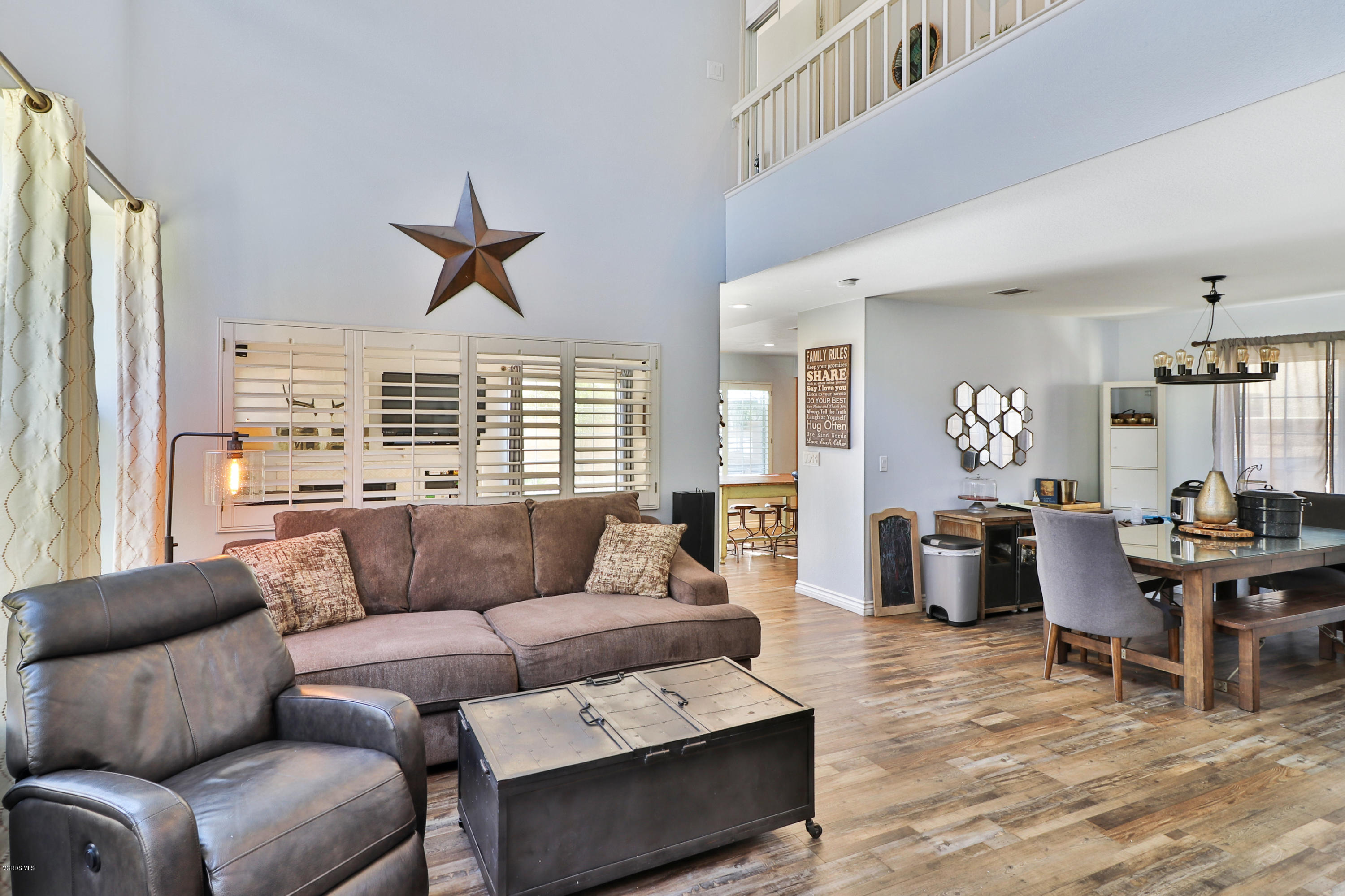 1729 Empty Saddle Road Simi Valley, CA 93063 - Photo 3 of 28 a living room with furniture a large window and a dining table