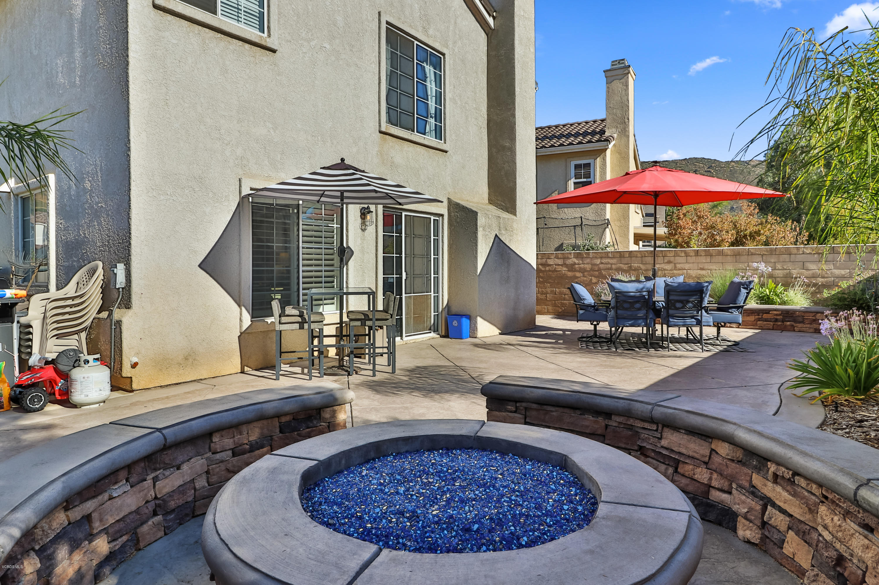 1729 Empty Saddle Road Simi Valley, CA 93063 - Photo 26 of 28 a view of a patio with table and chairs under an umbrella