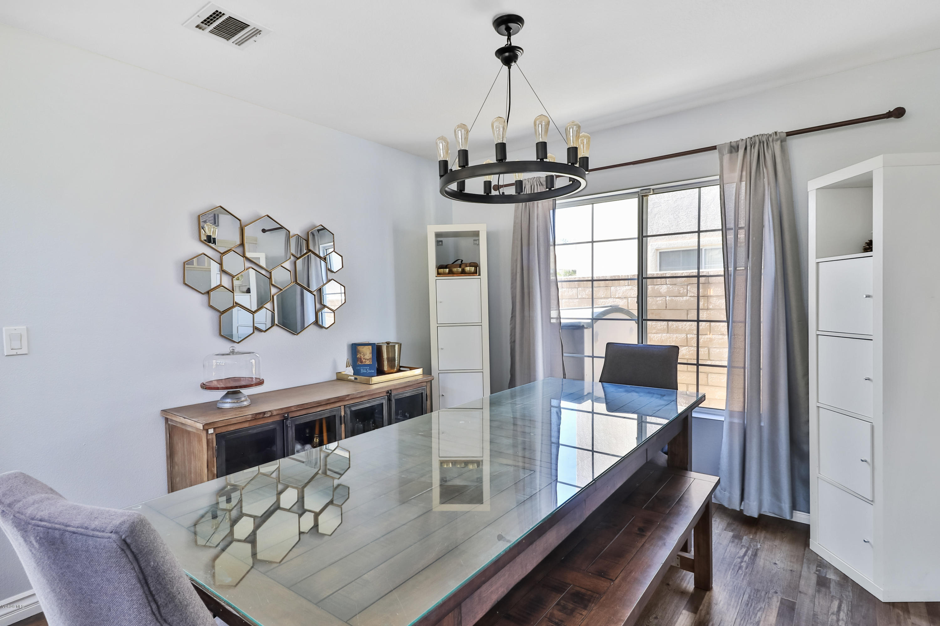 1729 Empty Saddle Road Simi Valley, CA 93063 - Photo 6 of 28 a view of a dining room with furniture a chandelier and wooden floor