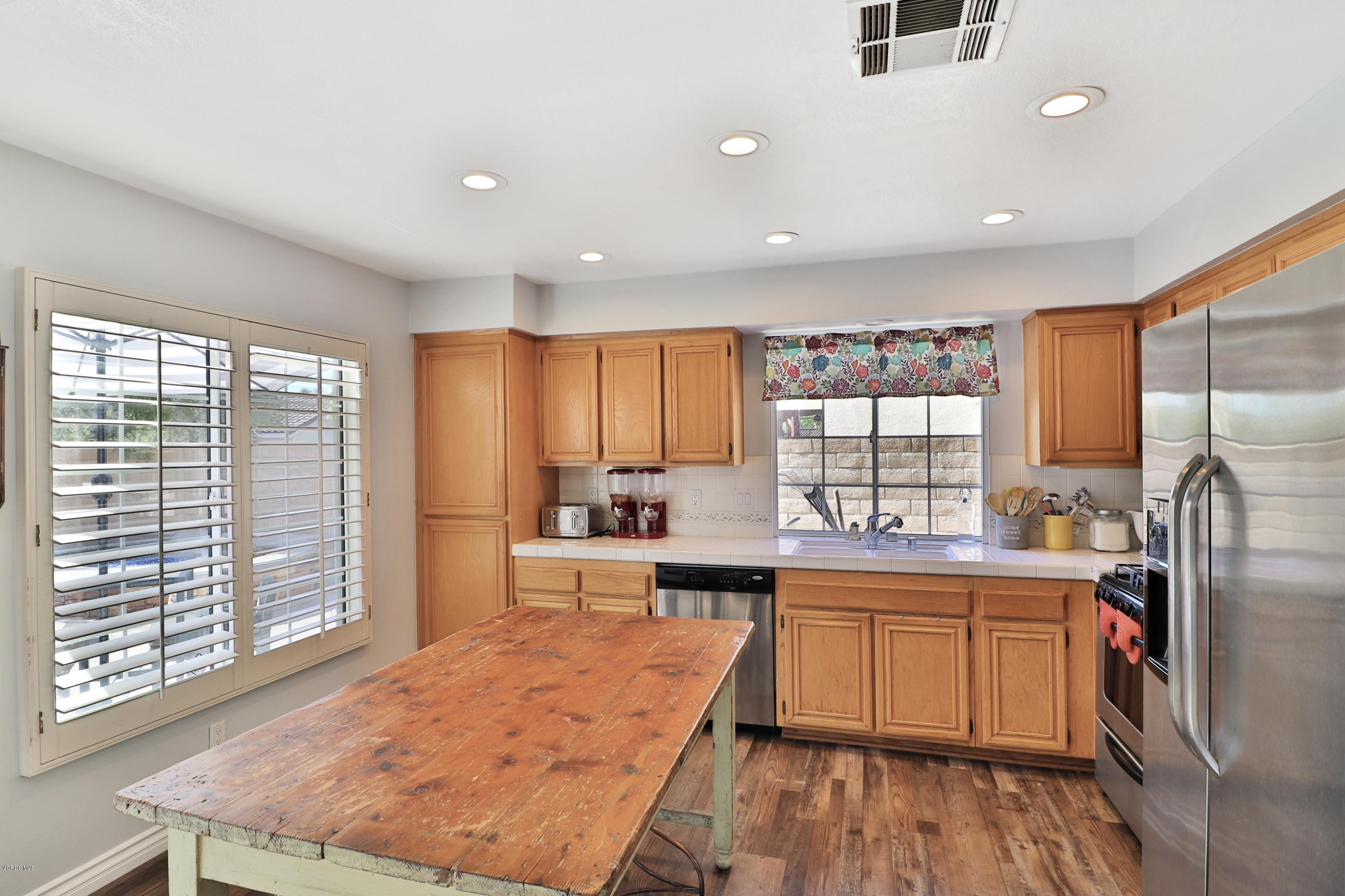 1729 Empty Saddle Road Simi Valley, CA 93063 - Photo 9 of 28 a large kitchen with a large window and stainless steel appliances