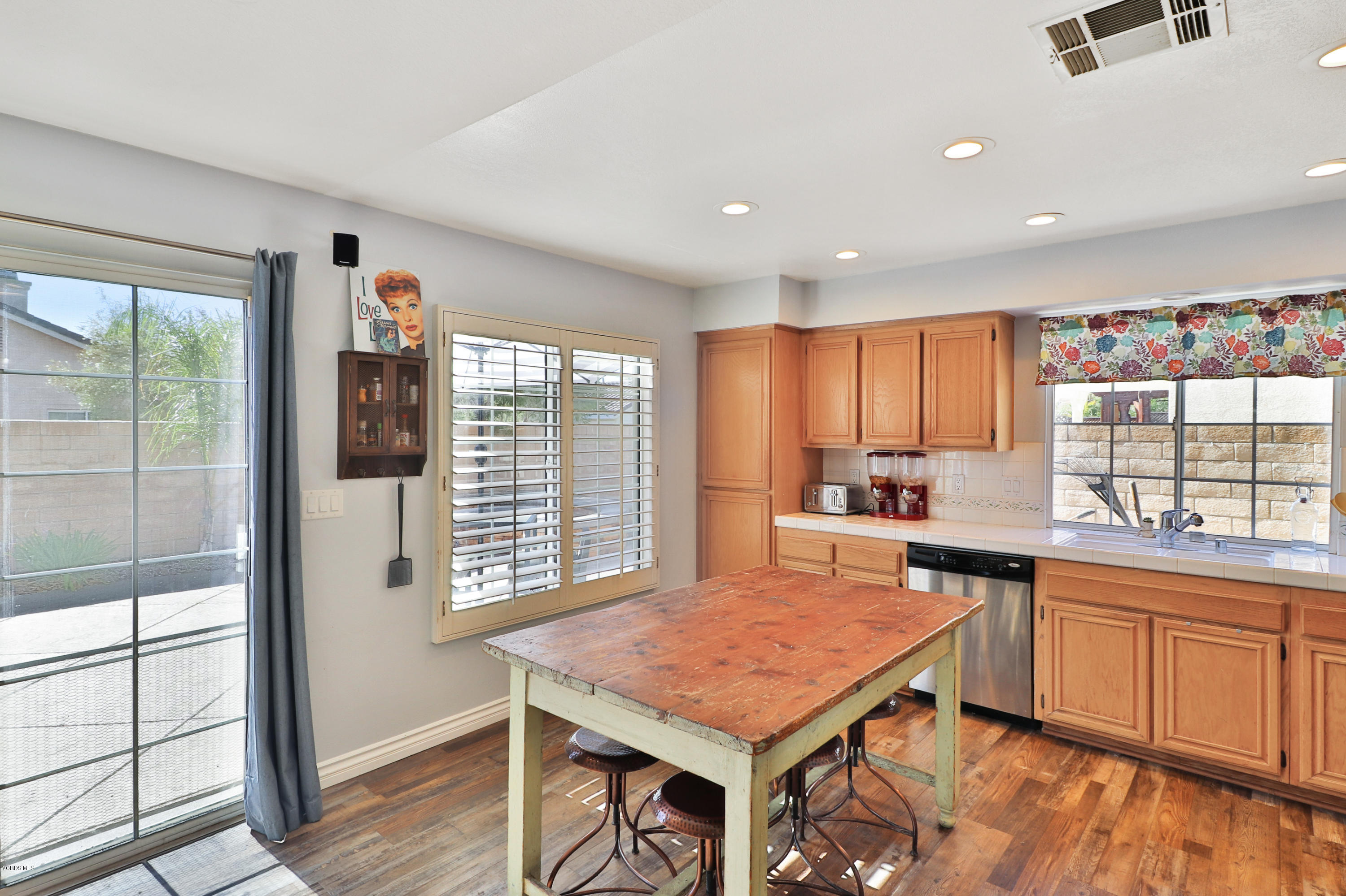 1729 Empty Saddle Road Simi Valley, CA 93063 - Photo 10 of 28 a kitchen with a stove a sink dishwasher and a refrigerator with wooden floor