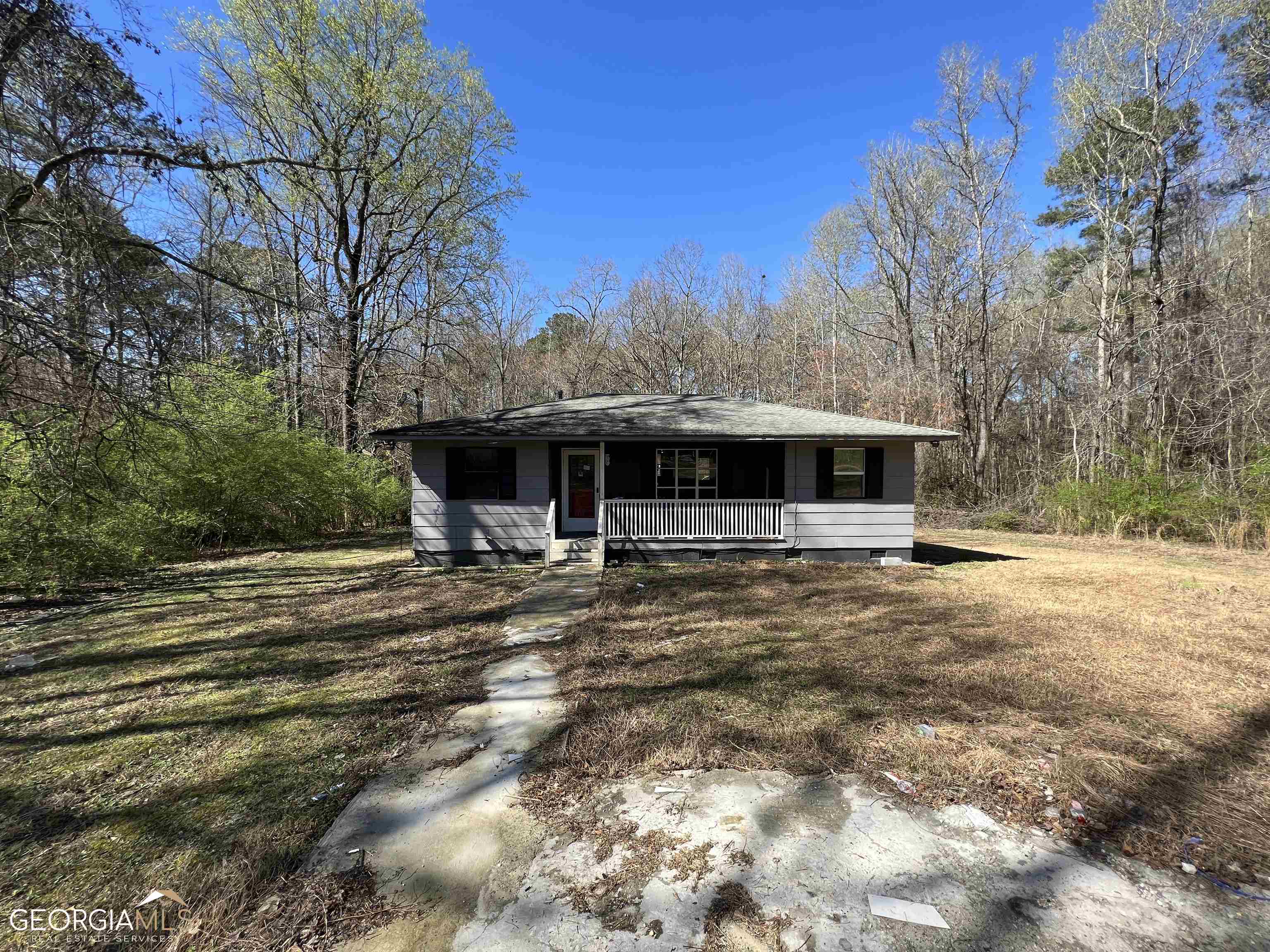 5925 Mallory Road South Fulton, GA 30349 - Photo 1 of 1 a view of a house with backyard and trees in the background