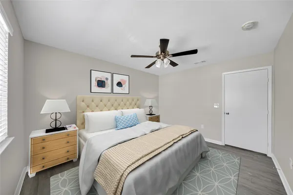 a bedroom with a bed and a ceiling fan