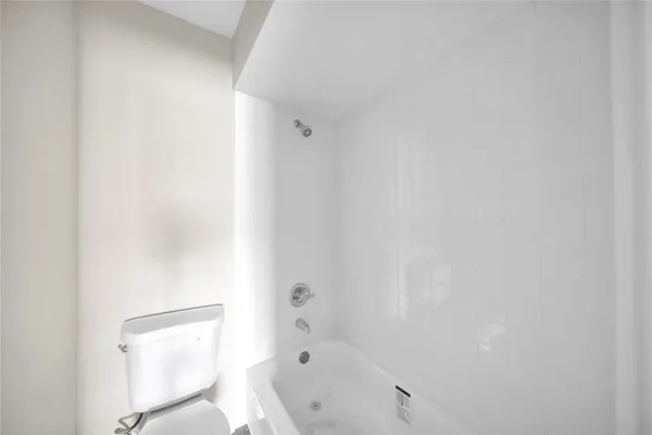 a bathroom with a bathtub and a toilet