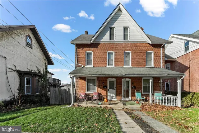 a front view of a house with garden and porch