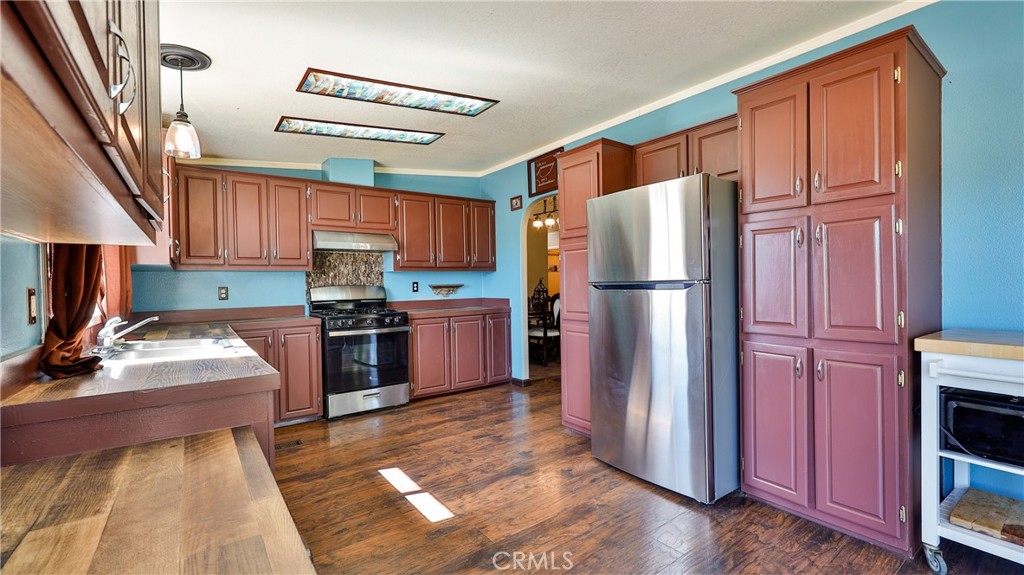39550 Kirby Road Anza, CA 92539 - Photo 5 of 53 a kitchen with granite countertop stainless steel appliances a refrigerator and a stove top oven