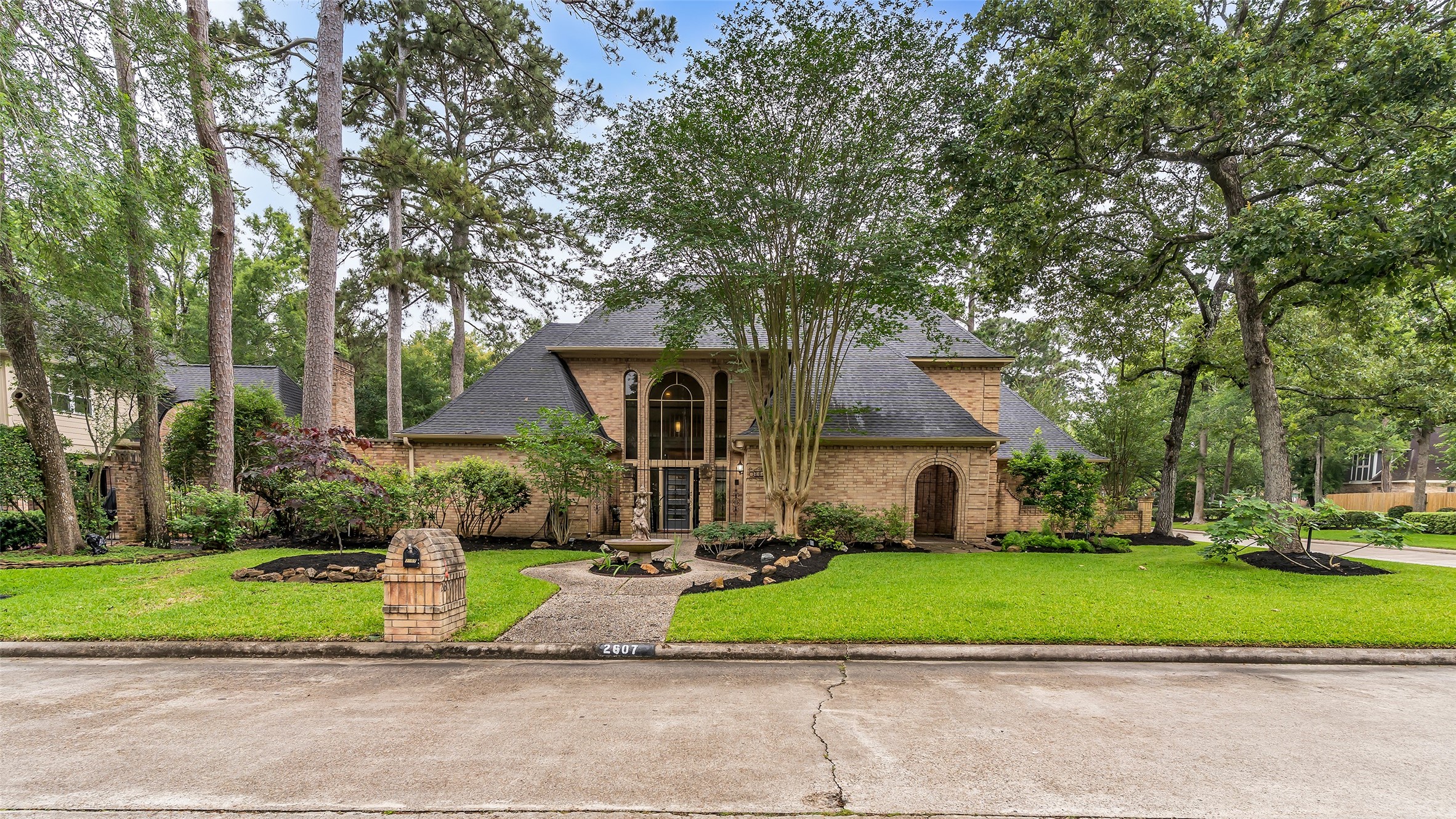 2607 Laurel Ridge Drive Houston, TX 77345 - Photo 2 of 47 a front view of a house with a yard and a garage
