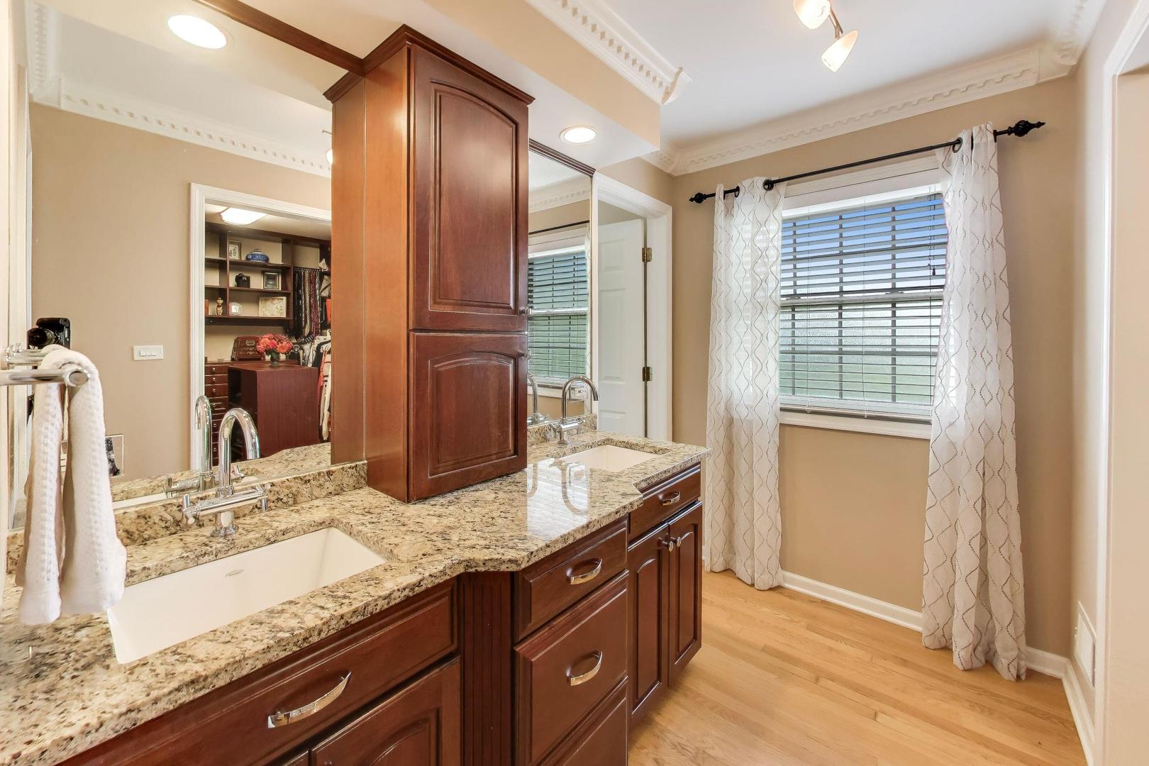 3956 Rutgers Lane Northbrook, IL 60062 - Photo 20 of 41 a bathroom with a granite countertop sink and a mirror