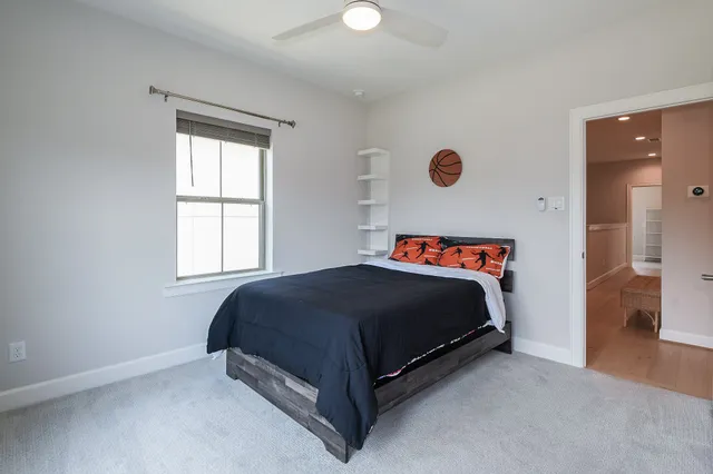 a bed sitting in a bedroom next to a window