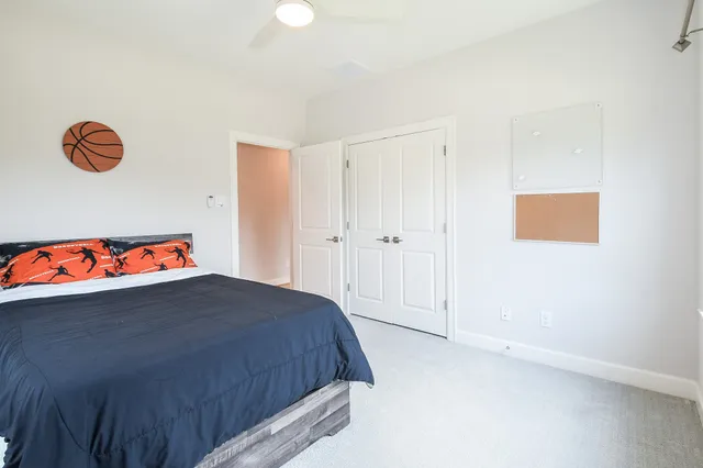 a bedroom with a bed and a book shelf