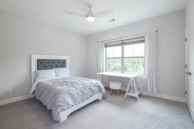 a bedroom with a bed and a table in it