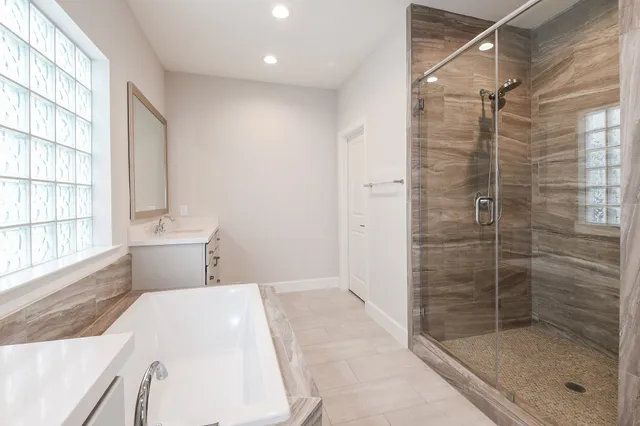 a bathroom with a shower and a sink