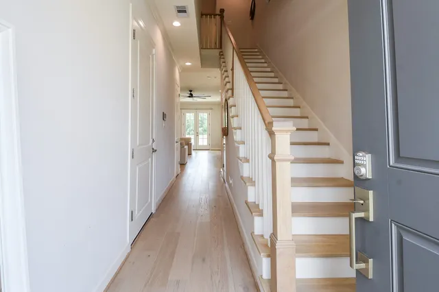 a view of a hallway with wooden floor and entryway