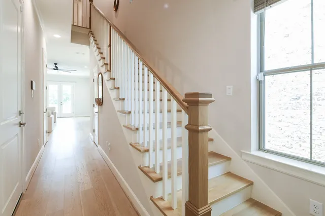 a view of hallway with stairs and wooden floor