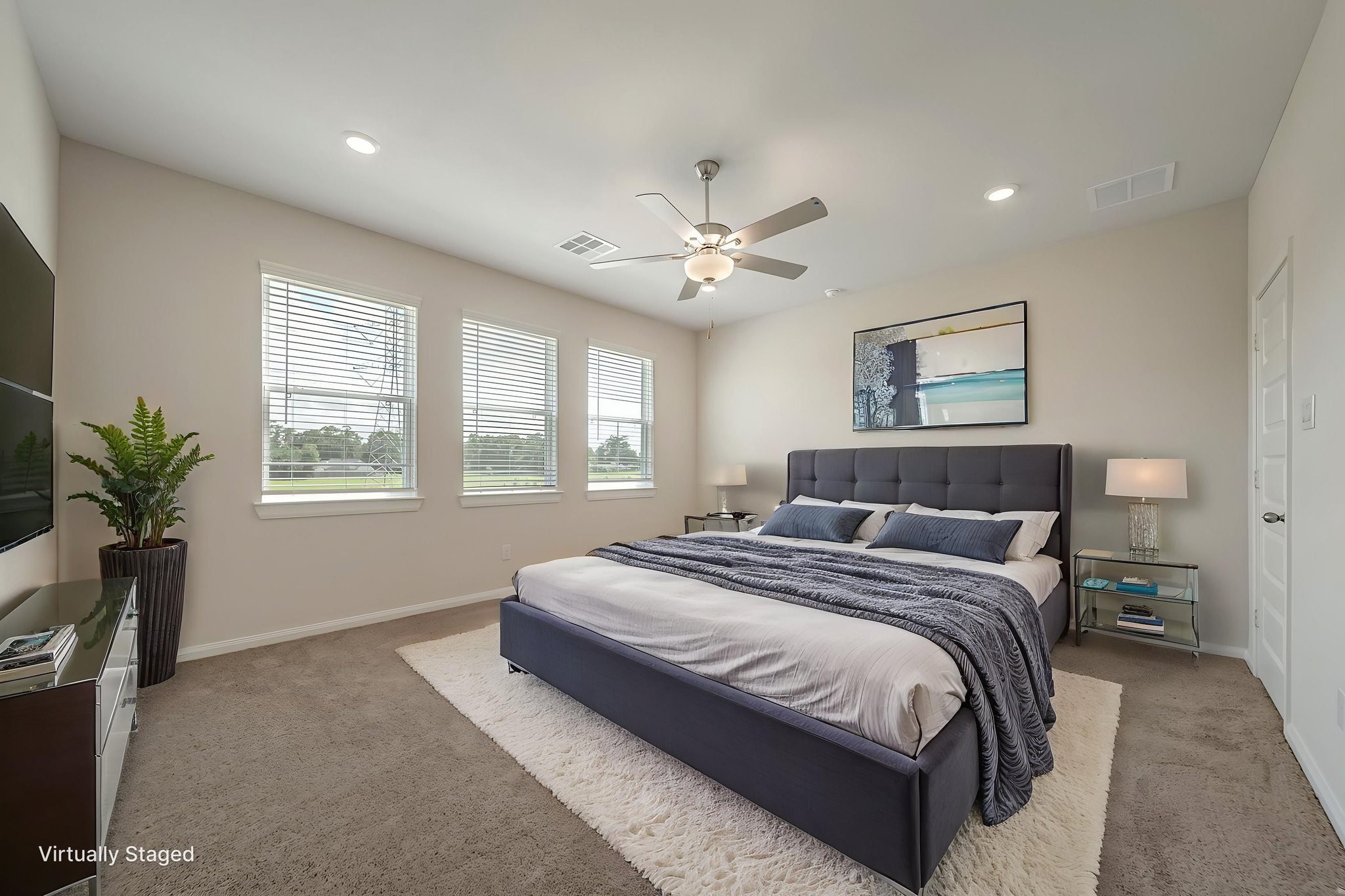 20629 Dynamic Court Humble, TX 77338 - Photo 10 of 26 a spacious bedroom with a large bed and a chandelier