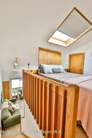 a bedroom with furniture and a large window