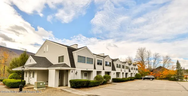 a front view of a residential apartment building with a yard