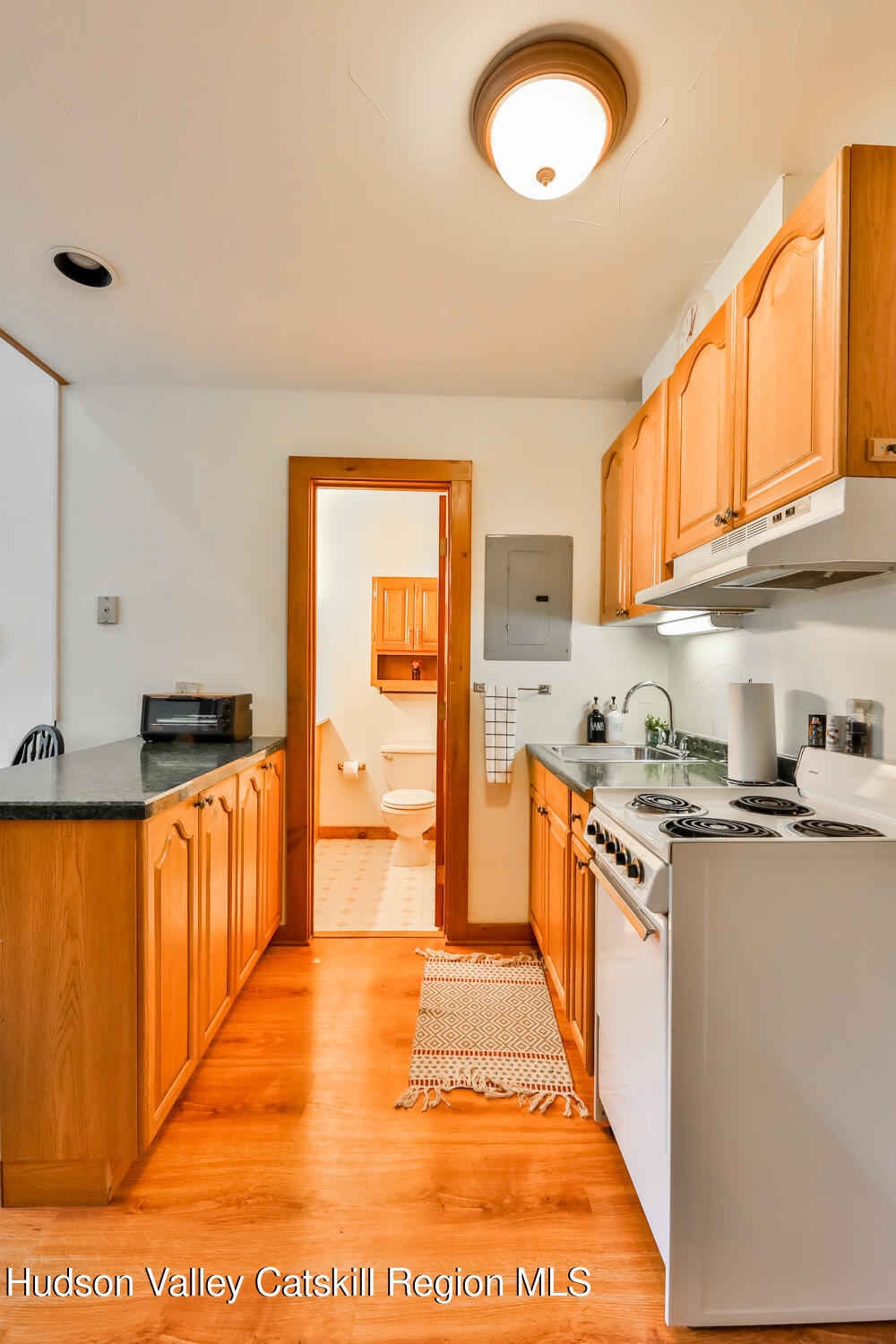 7675 Main Street, Unit B14 Hunter, NY 12442 - Photo 5 of 18 a kitchen with stainless steel appliances granite countertop a stove a sink and a refrigerator