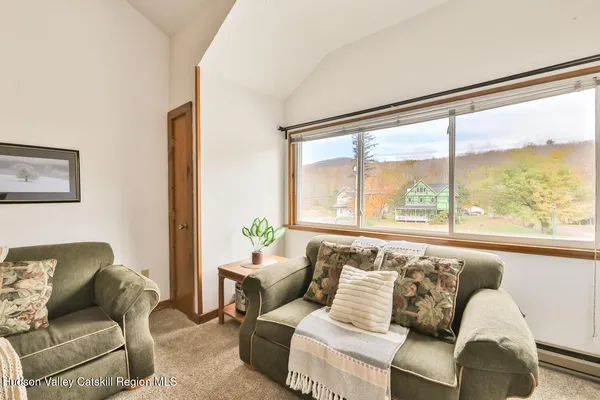 a living room with furniture and a large window with outer view