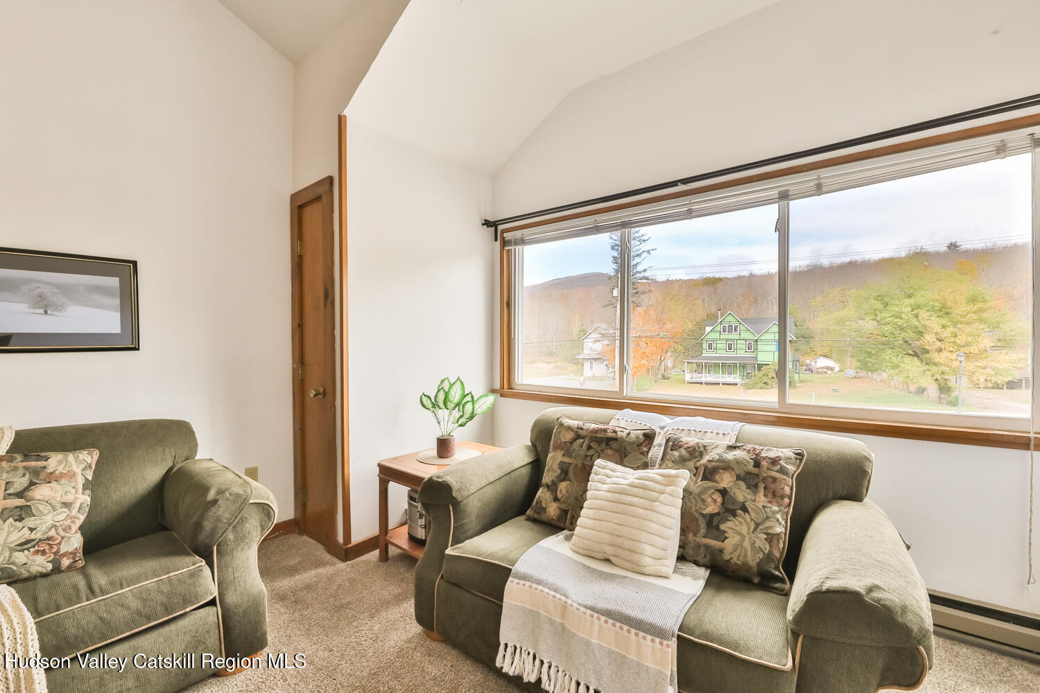 7675 Main Street, Unit B14 Hunter, NY 12442 - Photo 7 of 18 a living room with furniture and a large window with outer view