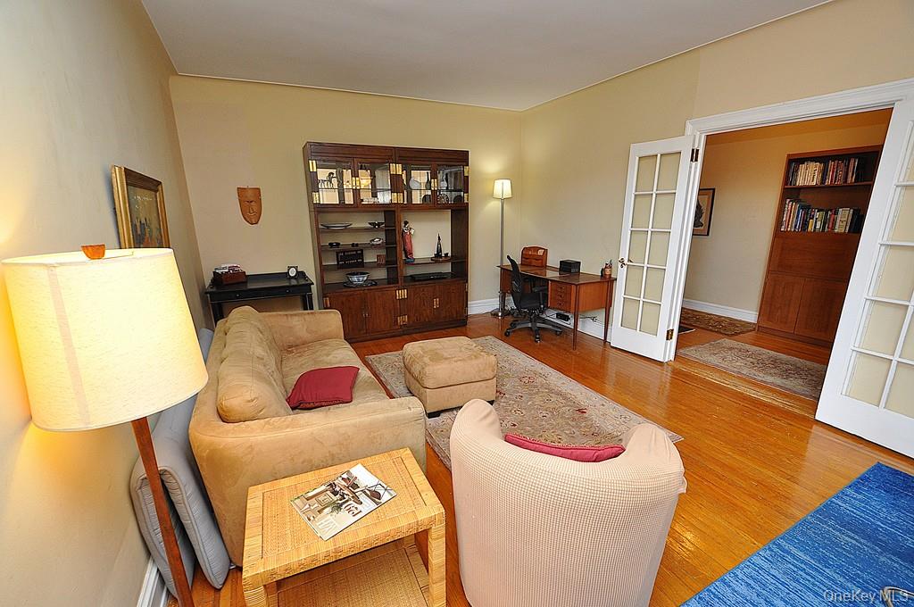 143 Garth Road, Unit 5J Scarsdale, NY 10583 - Photo 10 of 47 a living room with furniture and wooden floor