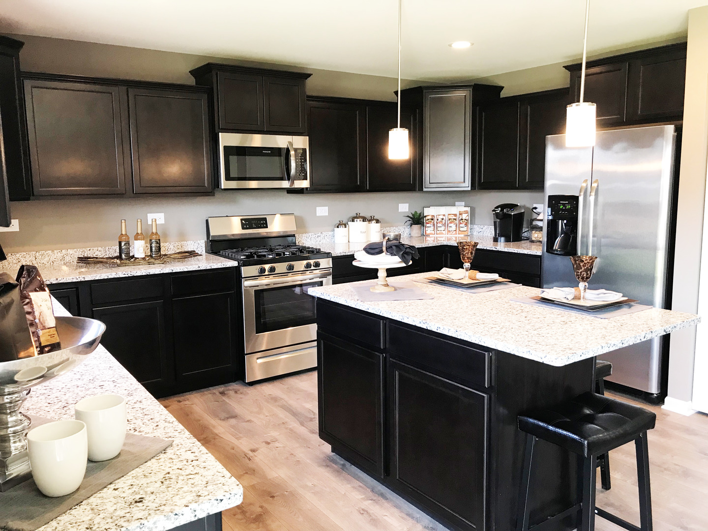 1978 Stapleton Road New Lenox, IL 60451 - Photo 2 of 48 a kitchen with a sink a stove a refrigerator and black cabinets