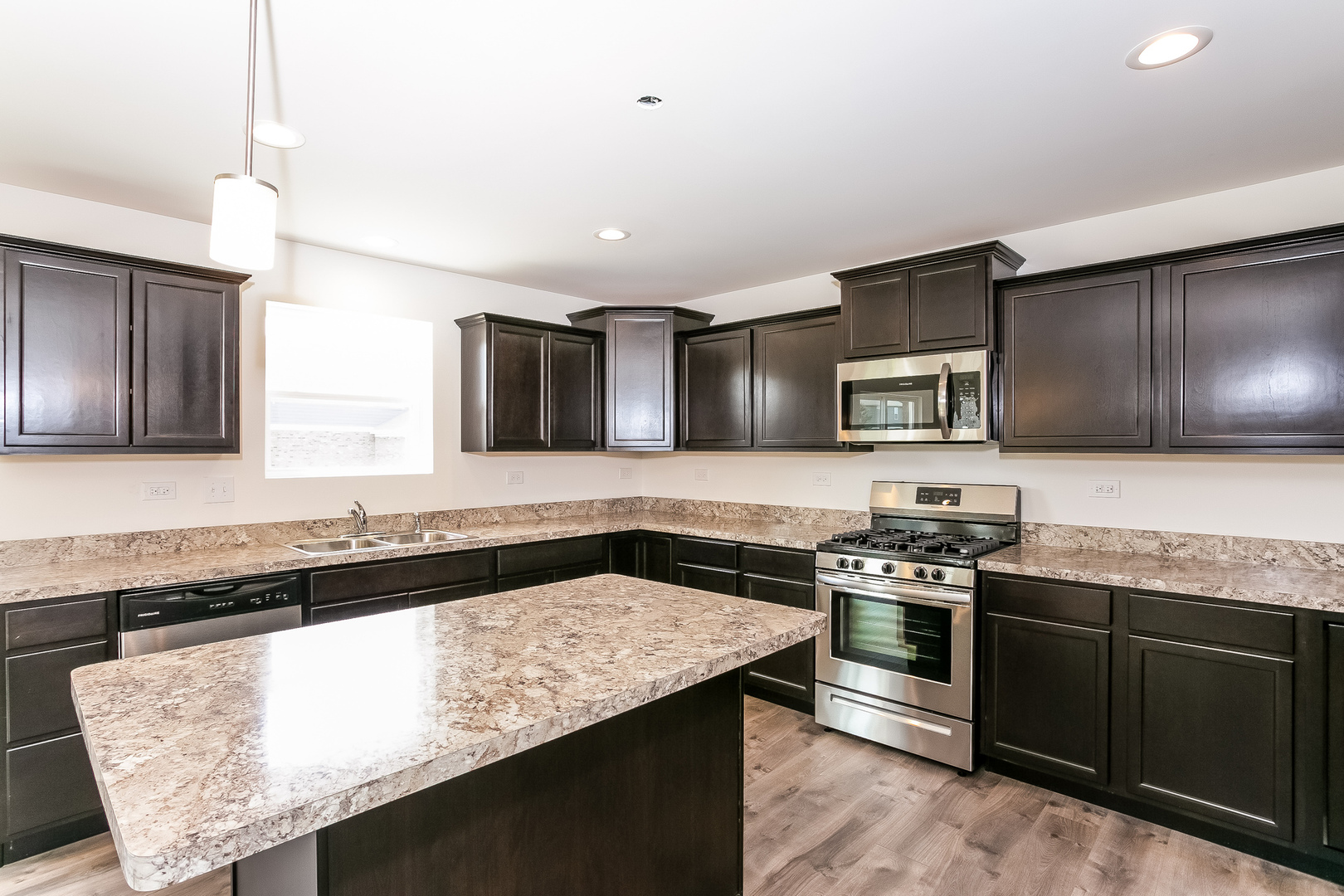 1978 Stapleton Road New Lenox, IL 60451 - Photo 24 of 48 a kitchen with stainless steel appliances granite countertop a stove a sink and a microwave
