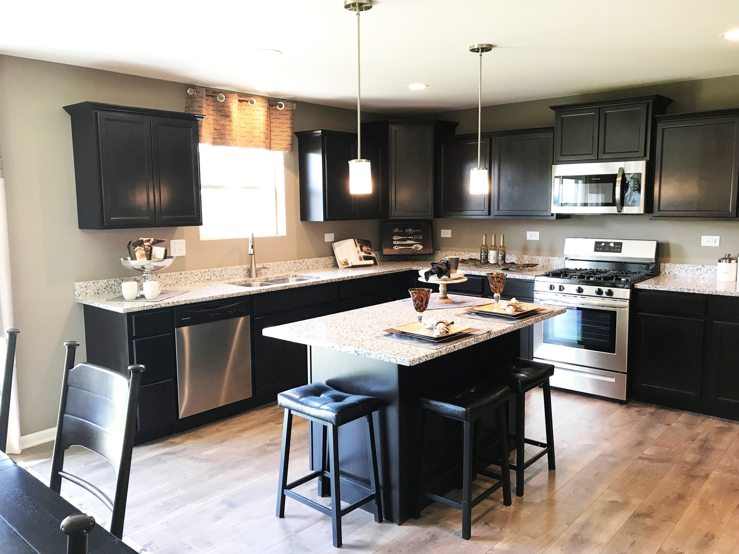 1978 Stapleton Road New Lenox, IL 60451 - Photo 3 of 48 a kitchen with a dining table chairs sink and stove
