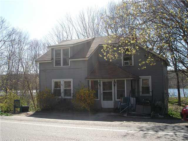 70 Inland Road Sprague, CT 06330 - Photo 1 of 1 a front view of a house with a yard and garage
