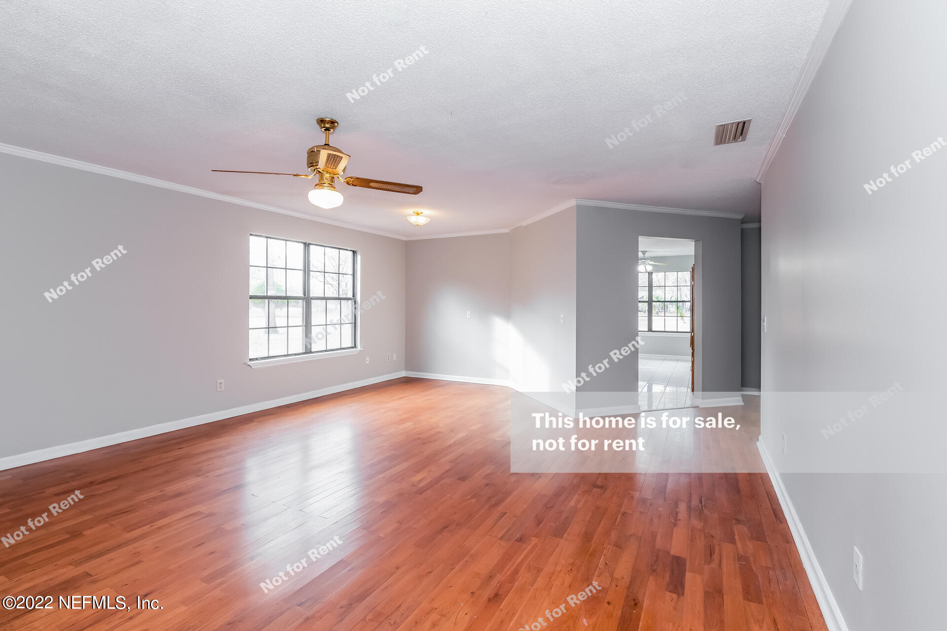 4205 Mustang Road Middleburg, FL 32068 - Photo 11 of 27 an empty room with wooden floor and windows