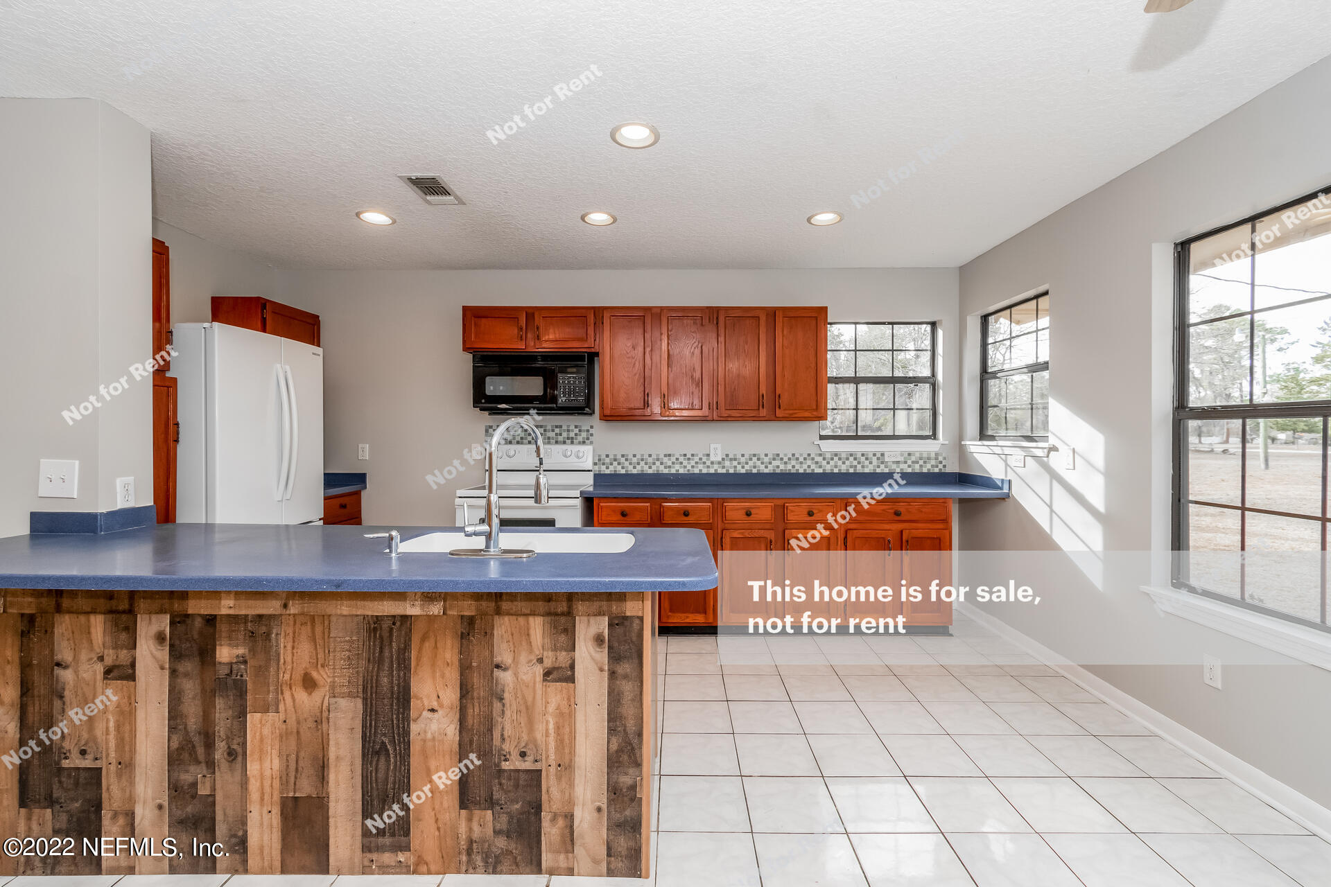 4205 Mustang Road Middleburg, FL 32068 - Photo 16 of 27 a kitchen with stainless steel appliances granite countertop a stove a sink and a granite counter tops with white cabinets