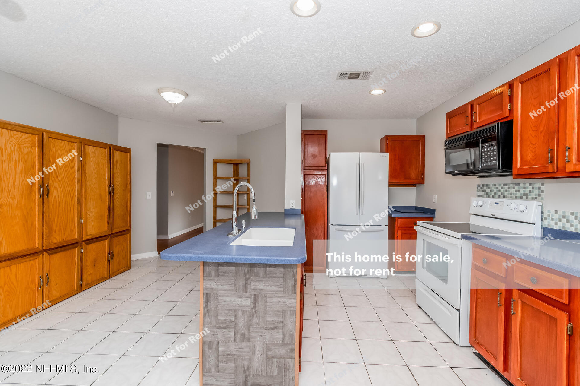 4205 Mustang Road Middleburg, FL 32068 - Photo 4 of 27 a kitchen with stainless steel appliances granite countertop a refrigerator and a sink