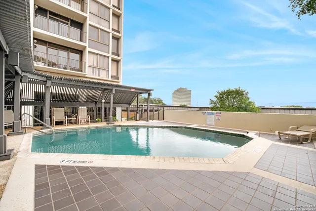 a view of a swimming pool with an outdoor seating