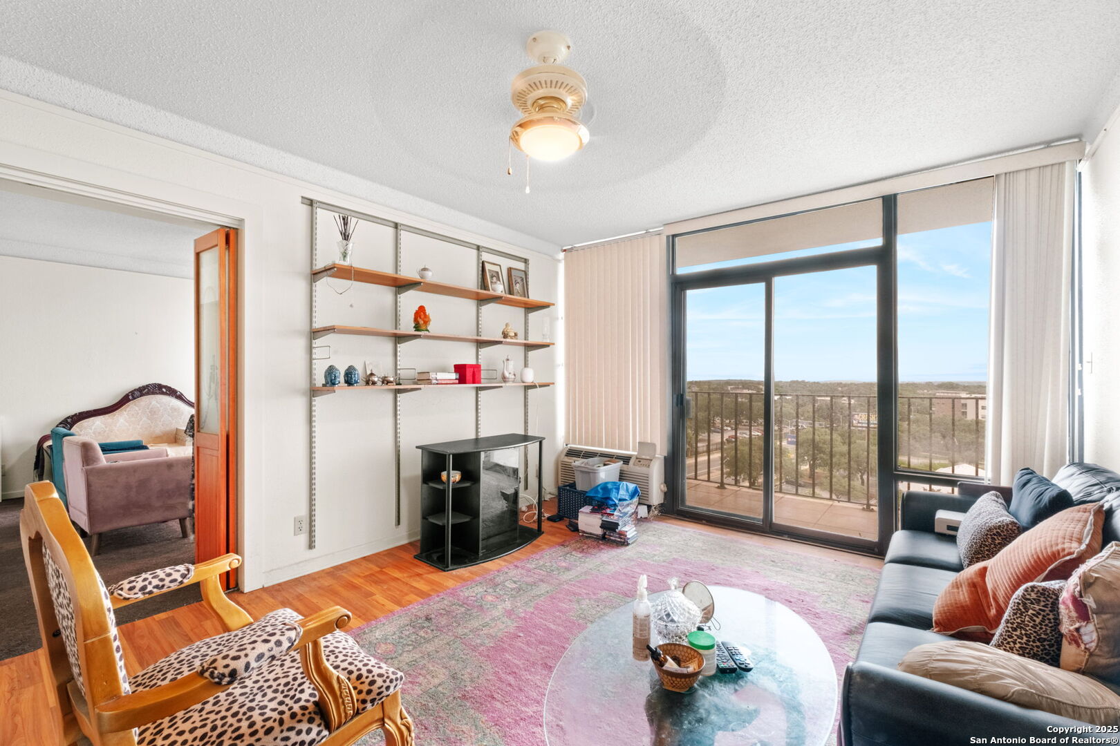 7701 Wurzbach Road, Unit 907 San Antonio, TX 78229 - Photo 12 of 25 a bedroom with furniture and a floor to ceiling window