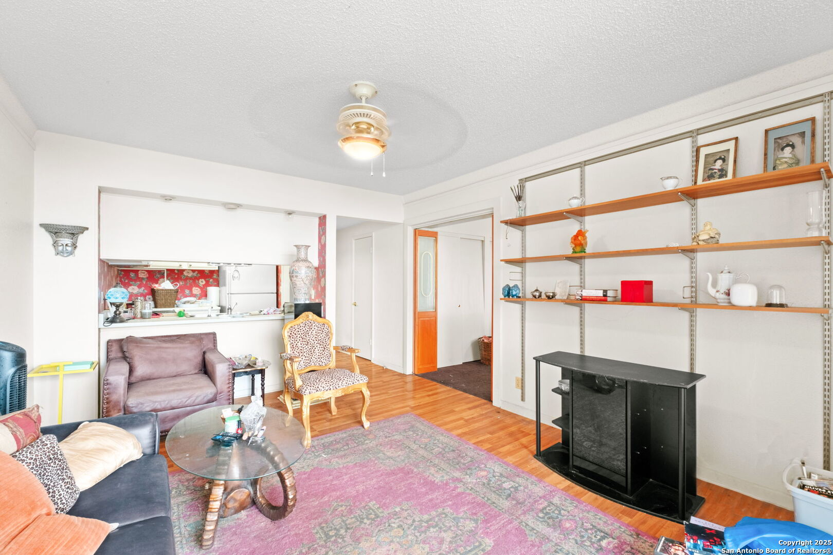 7701 Wurzbach Road, Unit 907 San Antonio, TX 78229 - Photo 13 of 25 a living room with furniture and a wooden floor