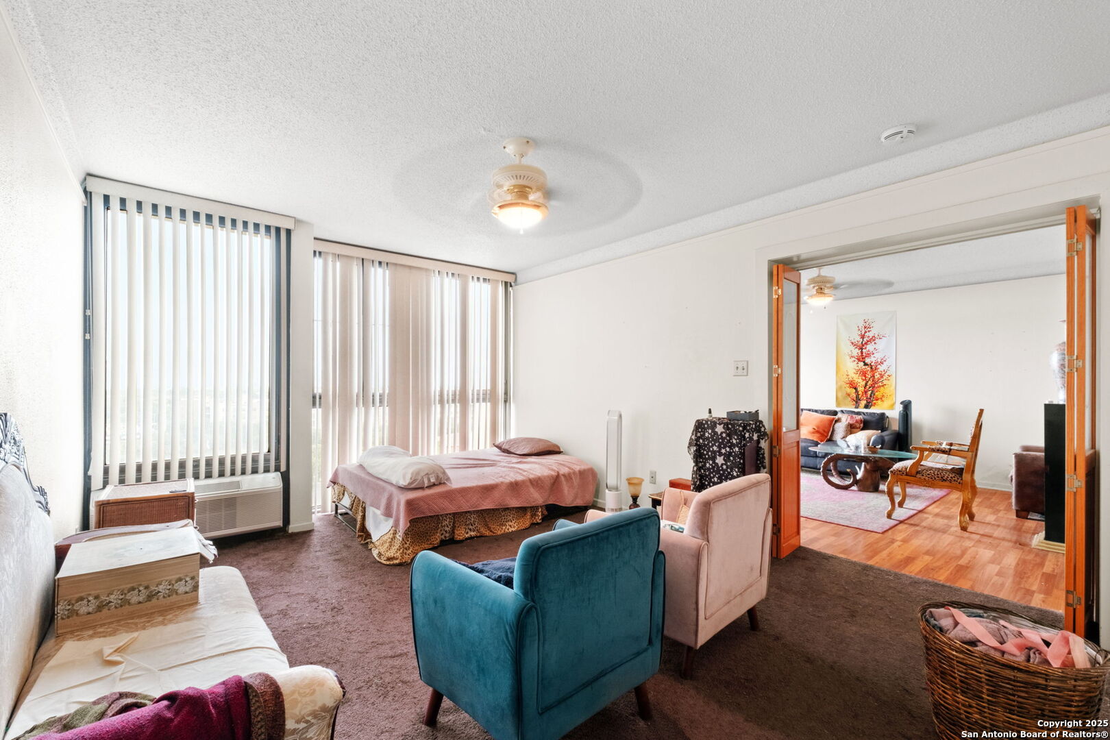 7701 Wurzbach Road, Unit 907 San Antonio, TX 78229 - Photo 14 of 25 a living room with furniture and floor to ceiling window