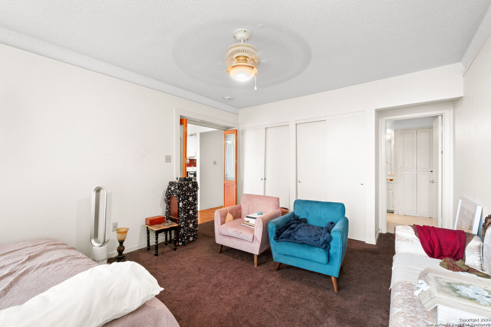 7701 Wurzbach Road, Unit 907 San Antonio, TX 78229 - Photo 16 of 25 a bedroom with furniture and a chandelier