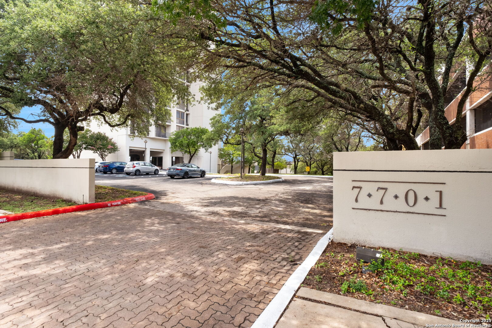 7701 Wurzbach Road, Unit 907 San Antonio, TX 78229 - Photo 2 of 25 a street sign on a sidewalk next to a road
