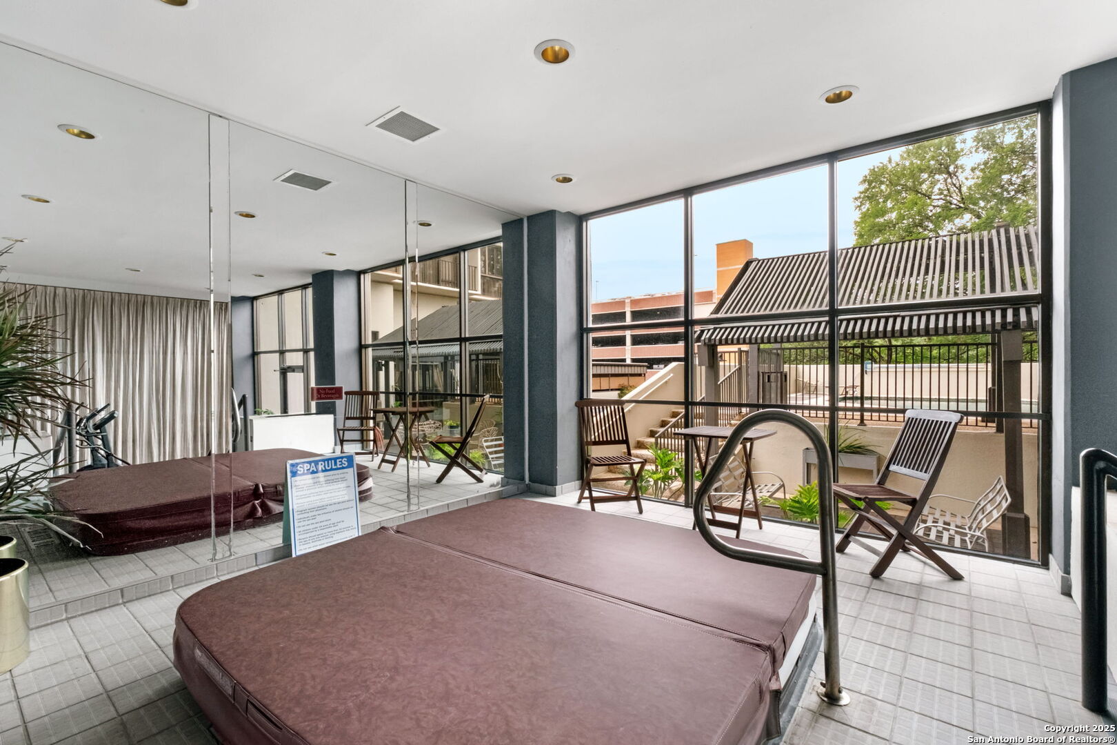 7701 Wurzbach Road, Unit 907 San Antonio, TX 78229 - Photo 23 of 25 a bedroom with furniture and a large window