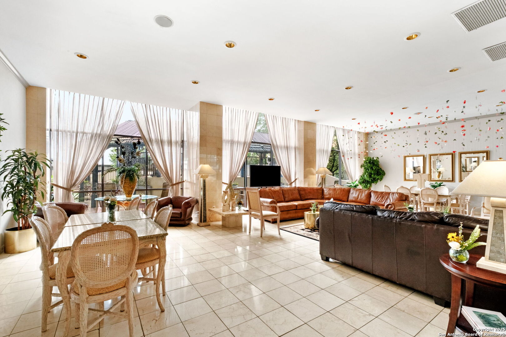 7701 Wurzbach Road, Unit 907 San Antonio, TX 78229 - Photo 3 of 25 a living room with fireplace furniture and floor to ceiling windows