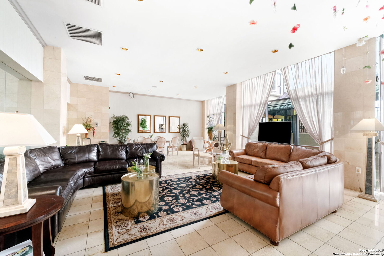 7701 Wurzbach Road, Unit 907 San Antonio, TX 78229 - Photo 5 of 25 a living room with furniture and a large window