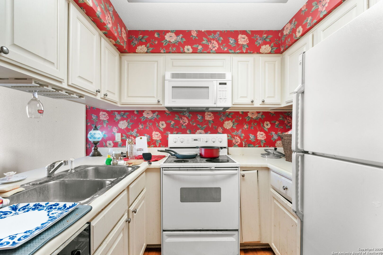 7701 Wurzbach Road, Unit 907 San Antonio, TX 78229 - Photo 9 of 25 a utility room with stainless steel appliances a sink and a refrigerator