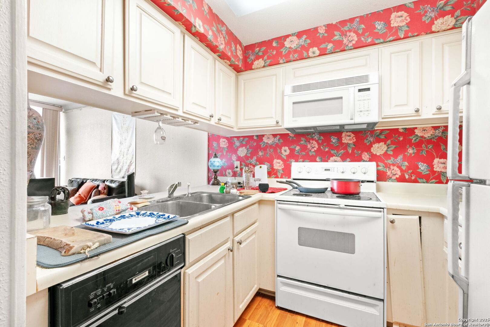 7701 Wurzbach Road, Unit 907 San Antonio, TX 78229 - Photo 10 of 25 a kitchen with white cabinets sink and white appliances