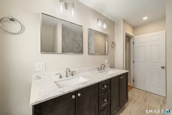 a bathroom with a sink double vanity and a mirror