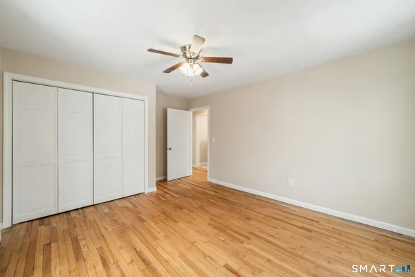 a view of an empty room with wooden floor