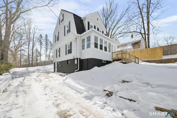 a view of large building with a yard covered in snow