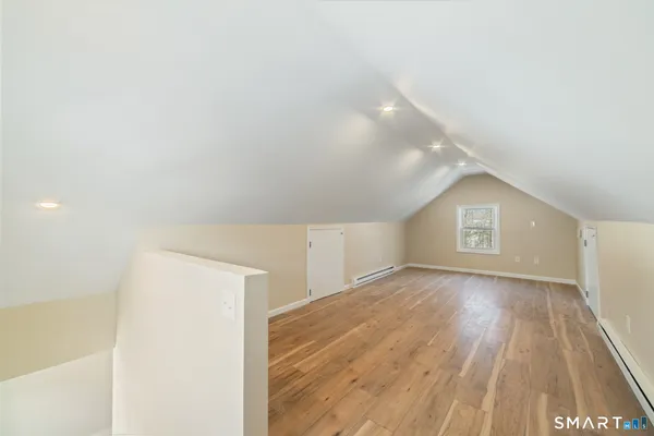 a view of an empty room and wooden floor