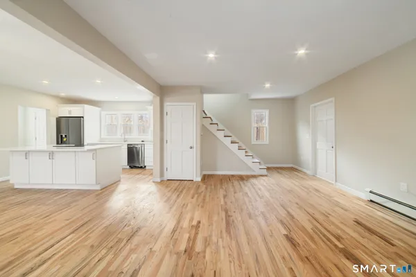 a view of a kitchen with wooden floor and a sink
